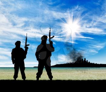 Concept of a terrorist attack. Silhouette of terrorists with a rifle on a background of the city in smoke