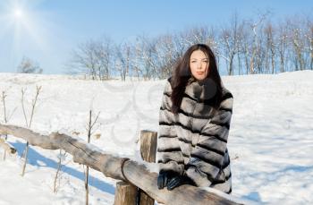 Happiness emotions concept. Young female model in a fur coat in the winter