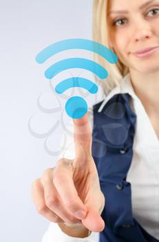 Concept of wireless Internet Wi fi. Business woman clicks on the icon Wi fi