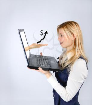 Concept of profit. Surprised woman holding a laptop and hand with positive schedule