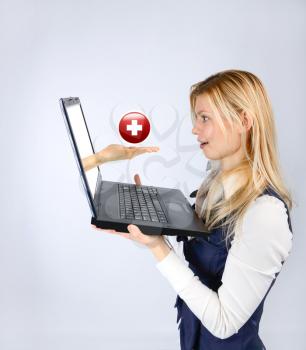 Advertising Medicine and the Red Cross. A woman looks at the advertising of medicine at laptop