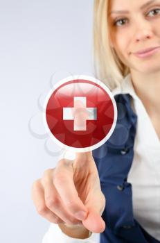 Concept of medicine and the Red Cross. Woman clicks on the icon of the Red Cross