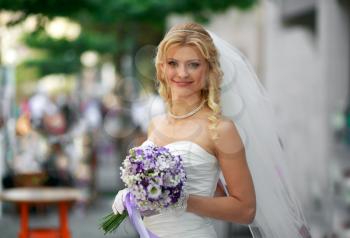 Portrait of a happy bride with a bouquet of bright