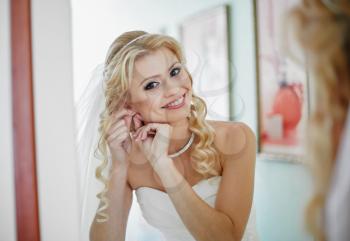 Wedding concept feelings and emotions. Beautiful and elegant bride smiles is preparing for the wedding ceremony