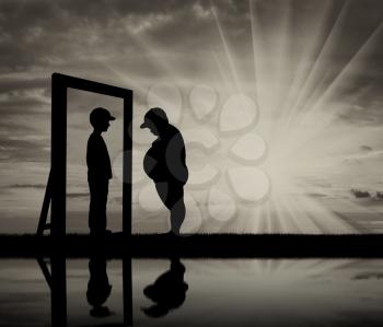 Fat boy and his reflection in the mirror of a normal boy against sky. Obesity concept