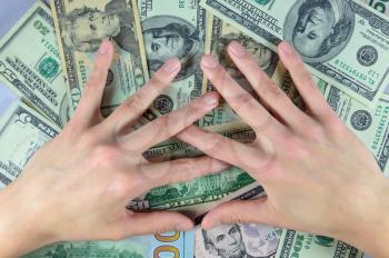 Concept of money. Human hands on a pile of dollars money