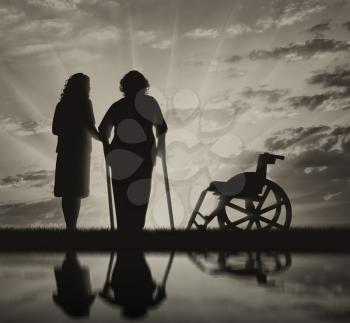 Silhouette disabled near the wheelchair and peepers. The concept of a disabled person and the home for elderly
