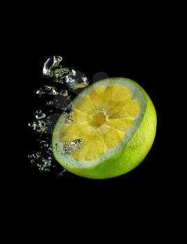 Half a lime fruit in water on a background of bubbles