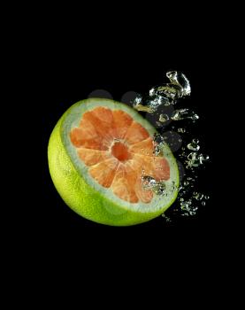 Half of citrus fruit in water on a background of bubbles