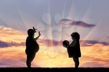 Fat boy and a girl playing ball at sunset. Concept of childhood obesity