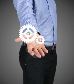 Business concept. Man's hand holding a gear mechanism. design element