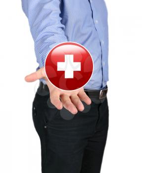 Concept of health and medicine. Business man holding a symbol of the Red Cross