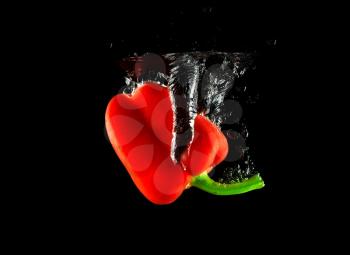 Vegetable red pepper in the water against a background of bubbles