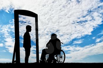 disabled man in a wheelchair and his reflection in mirror of a healthy man against the sky. disabled rehabilitation concept