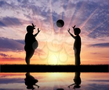Thick and normal boy and play ball and reflection in the water on the background of sunset. obesity concept