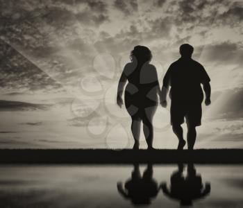Thick couple of people holding hands and reflection in water against the sky. obesity concept