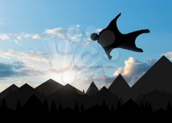 Wingsuit extreme sports. A man in a suit for wingsuit flying, mountains in background at sunset