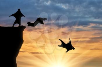 Wingsuit extreme sports. Men in suits for a wingsuit jump from a hill on a sunset background
