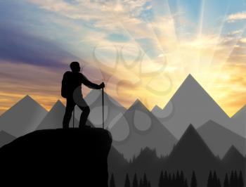 Silhouette of a climber on top looks into the distance over the mountains. success Concept