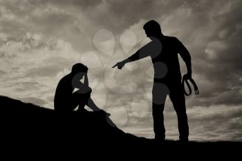 Child abuse and bullying in the family. Silhouette of crying boy afraid and aggressive drunken father with belt in his hand