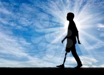 Walking disabled with prosthetic legs against the sky