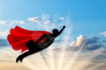 Superman businessman superhero. Silhouette of a businessman in the image of a superman flies in the sky with a briefcase on dawn