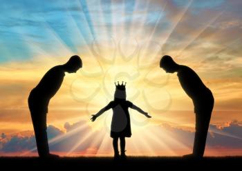 Selfish little girl with a crown on her head and two servants worship her. Concept of spoiled, selfish children