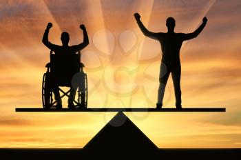A disabled person in a wheelchair equal rights in the balance with healthy. The concept of equal rights of persons with disabilities in society