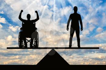 A disabled person in a wheelchair equal rights in the balance with healthy. The concept of equal rights of disabled people in society