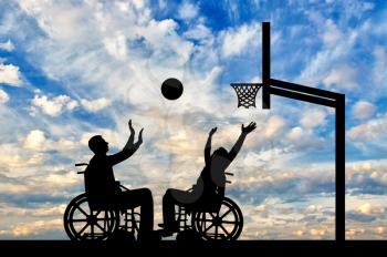 Two disabled people play wheelchair basketball. The concept of sports lifestyle people with disabilities