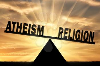 Word religion is more powerful than the word atheism on the scales. Conceptual image of religion