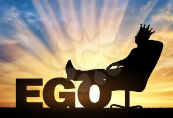 Selfish businessman sitting on an office chair with a crown on his head with his legs thrown back on the word ego. The concept of ego and arrogance