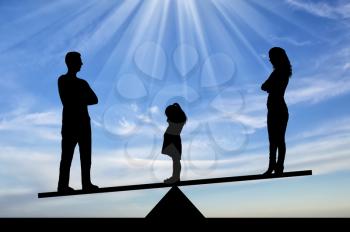 Divorce in the family. Silhouette of a little sad girl crying standing between mom and dad, chooses to stay with dad. The concept of divorce and division of children