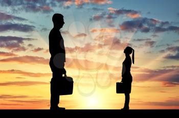 Silhouette of workers, a big man and a small woman. The concept of gender inequality in a career