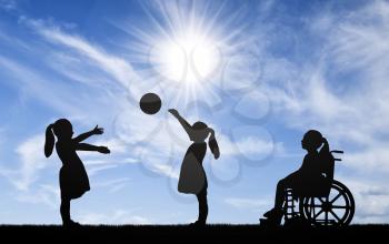 Silhouette of a disabled child girl in a wheelchair looking away as healthy children play in a ball outdoors. The concept of children with disabilities in a society of healthy children