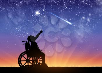 Silhouette of a disabled child girl sitting in a wheelchair showing a finger at a meteorite in a starry sky. Conceptual image of disabled children