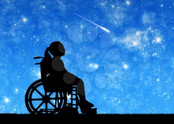 Silhouette of a disabled child girl sitting in a wheelchair looking at the starry sky. Conceptual image of disabled children