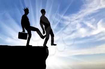 Silhouette, A male egoist with a crown is pushing another man into the abyss with his foot. Concept of selfishness and betrayal in business