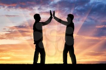 Silhouette of men make a gesture, give five. The concept of mutual benefit