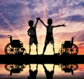 Children's disability concept. Two happy boy with a disability with a prosthetic leg standing near a wheelchair at the river with their reflection