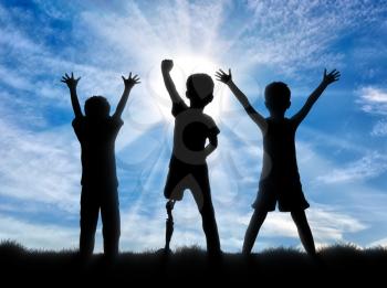 Children with disabilities in society concept. Happy disabled boy with a prosthetic leg standing among his friends, on sky background