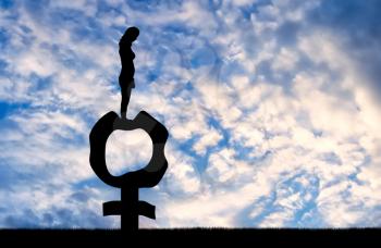 Silhouette of a sad woman standing on a female gender symbol that became flabby and wrinkled. Conceptual image about the inevitable menopause in women