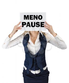 A woman in a suit standing holding a piece of paper with the word menopause at the level of the face. Conceptual image menopause in women