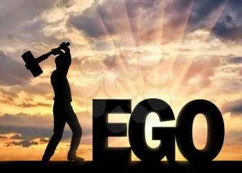 Man with a hammer in his hand intends to destroy the word ego. Concept of choosing to be selfish or not