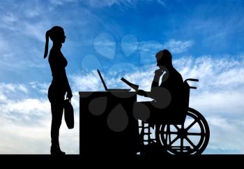 Silhouette of a man a businessman disabled in a wheelchair sitting at a table holds an interview with a woman about hiring a job. The concept of working disabled people