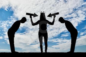 Silhouette of a selfish woman with a crown on her head trying to attract attention. The servants worship her. The concept of selfishness and narcissism