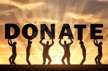 Altruism concept. Group of men holds the letters Donate on a sunset background