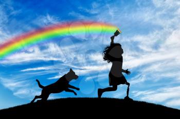 Children's disability concept. Child has a disability with a prosthetic leg with a brush in hand runs and draws a rainbow in sky with his dog