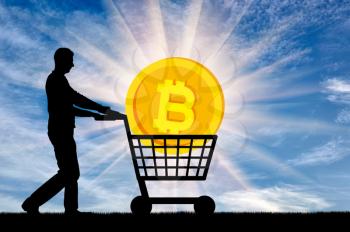 Silhouette of a man and bitcoin in a grocery cart. The concept of purchasing crypto currency