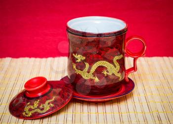 Beautiful red tea cup with a gold dragon and lid.